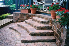 Red brick patio with arced stairs