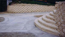 Tan paver stairs and wall with gray walkway