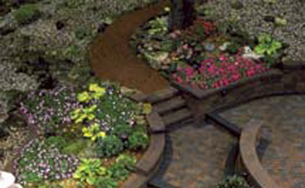 Paver path of brown bricks that also has steps and retaining walls for flower beds