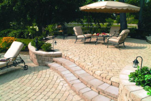 Circular patterned upper and lower yellow pavers patios connected by steps