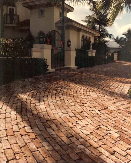 Cobblestone-style orange paver driveway