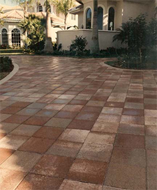 Walkway made of large sqares of orange and tan paver stones