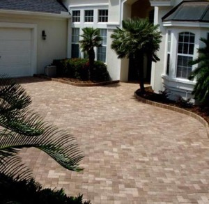Large brick paved driveway and front door entrance