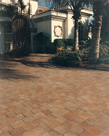 Driveway of square tan brick pavers