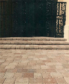Entranceway with tan pavers and steps